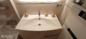 a white sink in a bathroom with a shower at Appartement de Luxe à Torcy in Torcy