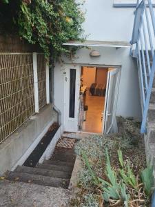 an open door to a house with a porch at Joli studio décoré proximité cure centre ville in Rochefort