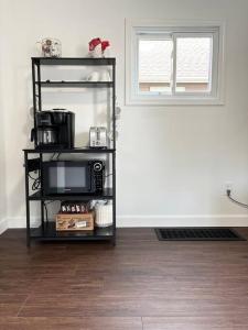 a microwave on a shelf in a room at Cozy home in Akron in Akron
