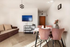 a living room with a table and chairs and a couch at M&B Green Oasis with pool and jacuzzi in Bibinje