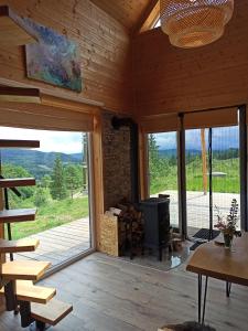 a living room with a large sliding glass door with a fireplace at Cisza & Natura - Kraina Wygasłych Wulkanów in Radzimowice