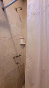 a shower with two faucets in a bathroom at La huella Jáchal - Casas de Campo in San José de Jáchal +30 photos