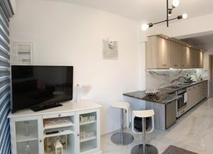 a kitchen with a flat screen tv on a counter at Dream View Preveza in Preveza