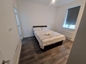 a bedroom with a bed with a teddy bear on it at Sweet Peace Home in Leeds