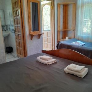 two folded towels sitting on a bed in a room at Guesthouse Sumaisha in Gulida +77 photos