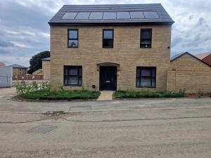 a brick house with solar panels on the roof at Sweet Peace Home in Leeds