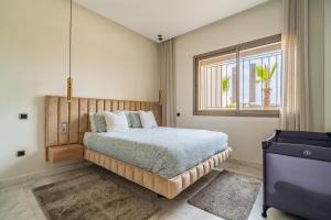 a bedroom with a large bed and a window at AeroSuite in Nouaceur
