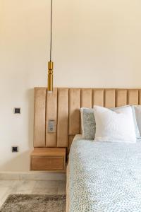 a bedroom with a bed and a pendant light at AeroSuite in Nouaceur