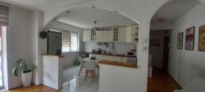 a kitchen with an archway in the middle of a room at Adriana's Apartment in Skopje