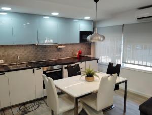 a kitchen with a table and chairs in a room at Apartamento Plaza Palmeras in Burjassot