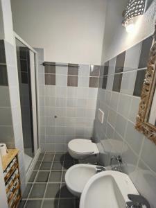 a bathroom with two toilets and a sink and a mirror at Maisonette Asfodelo in Palau +12 photos
