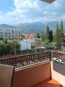 a balcony with a view of a building and mountains at Villa Roselina By Beatrix in Budva