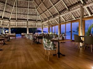 a restaurant with tables and chairs with a view of the ocean at Ocean Boutique Hotel - Adults only in Pingwe +54 photos