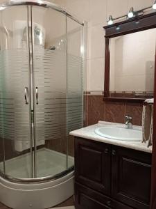 a bathroom with a glass shower and a sink at Villa Roselina By Beatrix in Budva +52 photos