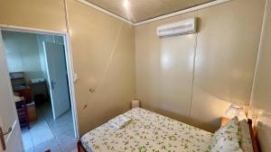 a small room with a bed and a air conditioner at Little Paradise Livadi Himare in Himare