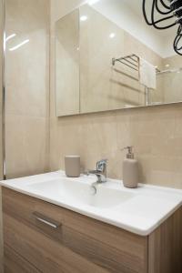 a bathroom with a white sink and a mirror at B&B Caracciolo 109 in Naples