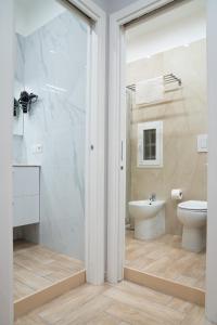 a bathroom with a shower and a toilet and a sink at B&B Caracciolo 109 in Naples