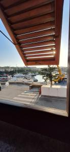 a window with a view of a parking lot at Casa dei bagnanti sul Porto Vecchio in Stintino