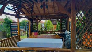 a wooden gazebo with a bed in it at Eduard House in Bumbeşti-Jiu