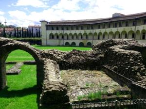 an old stone bridge in front of a building at Home & B in Arezzo