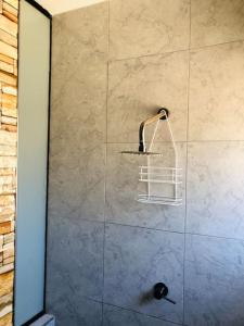 a shower with a glass door with a basket at Nuevo Apartamento en Máncora Las Pocitas in Máncora
