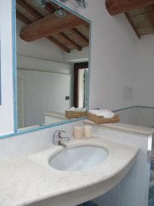 a bathroom with a sink and a mirror at Appartamento Il Pradello in Corinaldo +14 photos