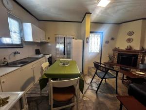 a kitchen with a table with a green table cloth on it at Lidden tree cottage in Perea