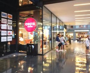 a group of people standing outside of a shopping mall at Prague centrum house in Prague