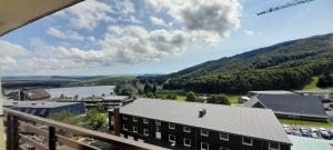 a view from a balcony of a building and a river at Appartement 40m2 T2 centre de station Super Besse in Besse-et-Saint-Anastaise +7 photos