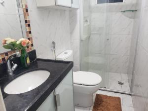 a bathroom with a sink and a toilet and a shower at Refugio Executivo Litoral in João Pessoa