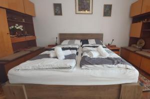 a bed with two pillows on it in a room at Nagyiék háza / Granny's House in Esztergom