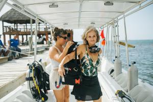 two women standing on a boat taking a picture at Tranquilseas Boutique Eco Resort & Dive Center in West End