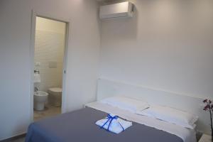 Ένα ή περισσότερα κρεβάτια σε δωμάτιο στο Il MARangolo di GioSo