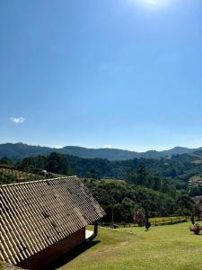 a wooden building sitting on top of a field at Pousada Vista do Paraíso in Monte Verde +107 photos