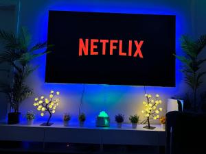 a sign that says netflix on a wall with plants at Rise Lodge in Brussels +6 photos