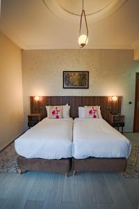 Posteľ alebo postele v izbe v ubytovaní Hotel Arabesque