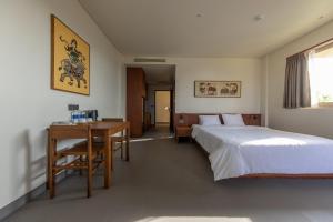Postel nebo postele na pokoji v ubytování Cát Vàng Hotel & Apartment