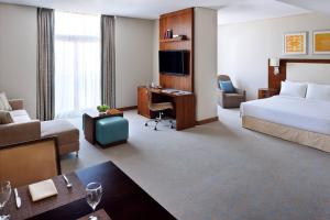 a large hotel room with a bed and a desk at Residence Inn by Marriott Kuwait City in Kuwait