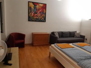 a living room with a bed and a couch at Apartment Dahlia Vienna in Vienna