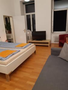 a living room with two beds and a couch at Apartment Dahlia Vienna in Vienna