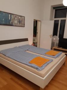 a bed with two orange napkins on top of it at Apartment Dahlia Vienna in Vienna