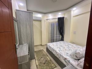 a small bedroom with a bed and a window at Princess Resort Hurghada in Hurghada