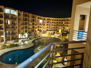 a view from a balcony of a hotel at night at Princess Resort Hurghada in Hurghada +1 photo
