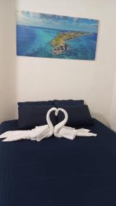 a white ribbon laying on top of a bed at Casa Azul in Isla Mujeres