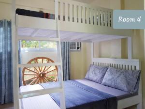 a bedroom with a bunk bed and a bunk bed with a ladder at Carms Villa Resort in Kidapawan