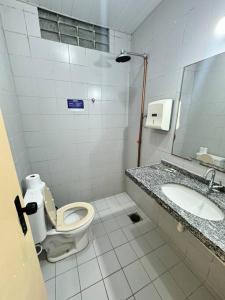 a bathroom with a toilet and a sink at Ap 2 quartos em bairro nobre com garagem in Sobral
