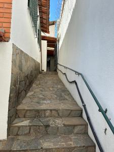 a stairway with a hand rail next to a building at Casa aconchegante Barroca in Belo Horizonte