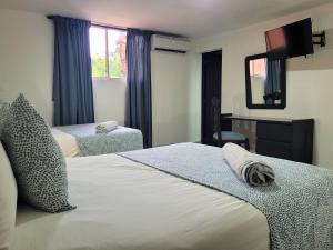 Postel nebo postele na pokoji v ubytování Hotel Olimpo