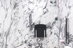 a bathroom with a white marble wall at The Wellesley, a Luxury Collection Hotel, Knightsbridge, London in London