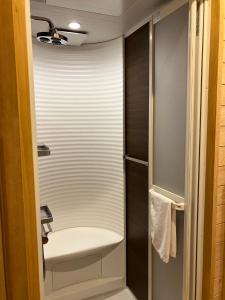 a small bathroom with a sink and a shower at MY LODGE Naoshima in Naoshima